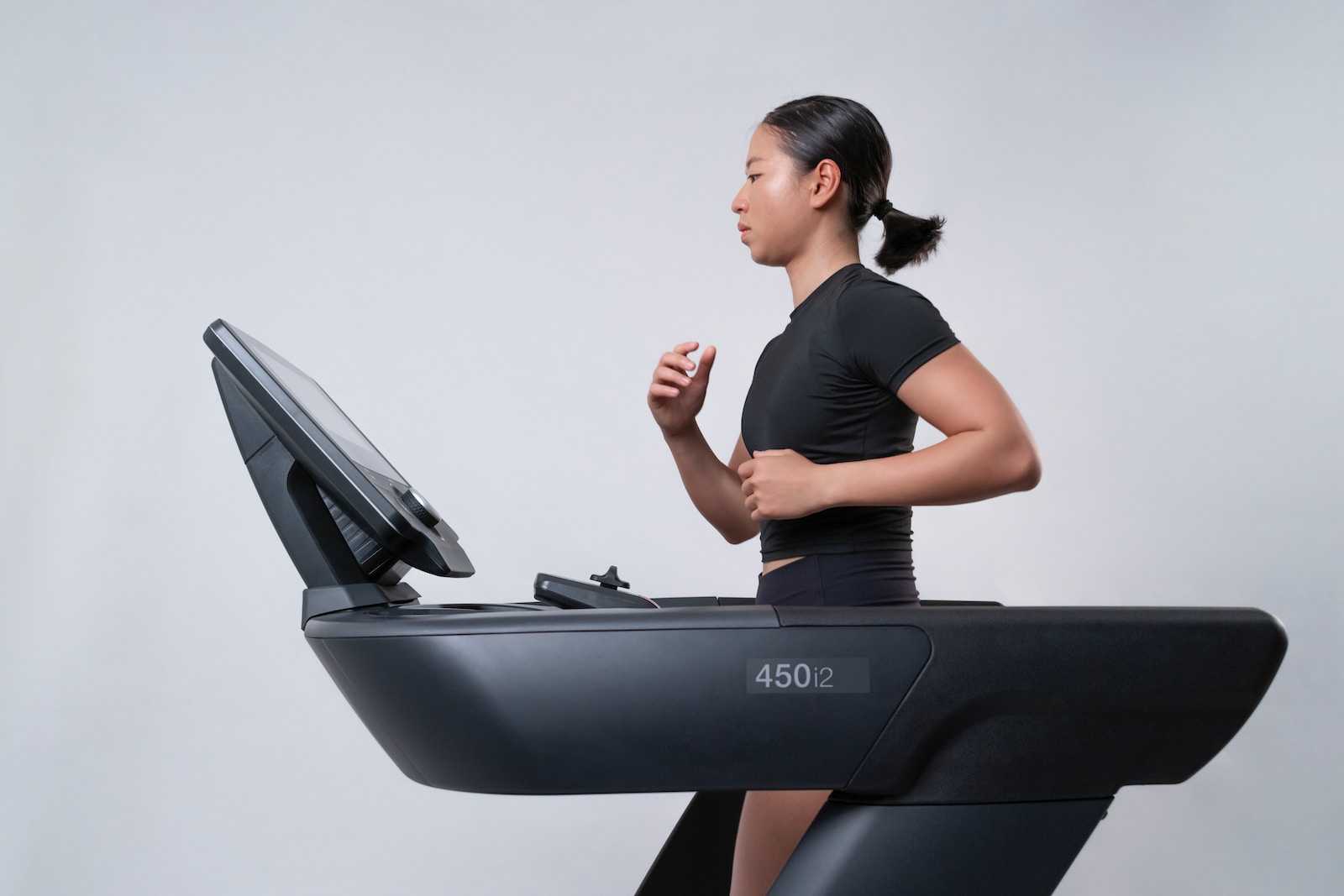 a woman is running on a treadmill